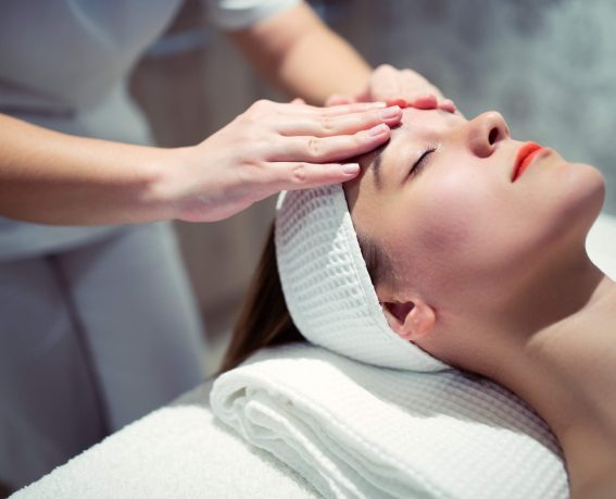 Facial massage treatment by professional at cosmetics saloon