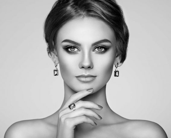 Portrait Beautiful Woman with Jewelry. Model Girl with Manicure on Nails. Elegant Hairstyle. Make-up Arrows. Beauty and Accessories. Black and White